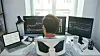 Trading stocks online. Back view of young businessman or trader working with graph and charts on