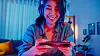 asia girl gamer wear headphone competition play video game online with smartphone.