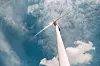 A white Windmill against a blue sky. Windmill in nature