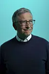 Bill Gates står foran en turkis bakgrunn og ser mot kamera.