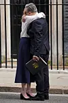 Keir Starmer omfavner sin kone Victoria utenfor 10 Downing Street mens han holder en mappe.