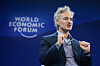 Alex Karp taler på scenen under World Economic Forum i Davos, med World Economic Forum-logoen i bakgrunnen.