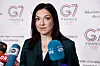 Katherina Reiche speaks to reporters in front of a G7 France backdrop in Paris.