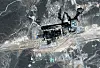 Satellittbilde av et skadet industriområde i ørkenen i Saudi-Arabia.